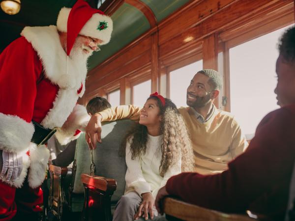 Santa greeting a family on a train in Lancaster, PA.