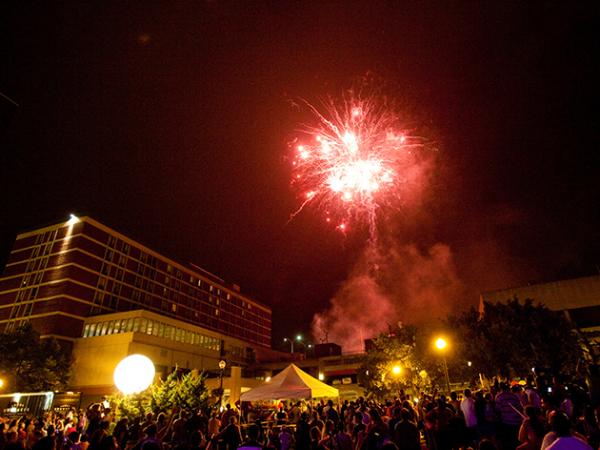 Crowd watches as a red firework explodes in the night sky over Lancaster, PA